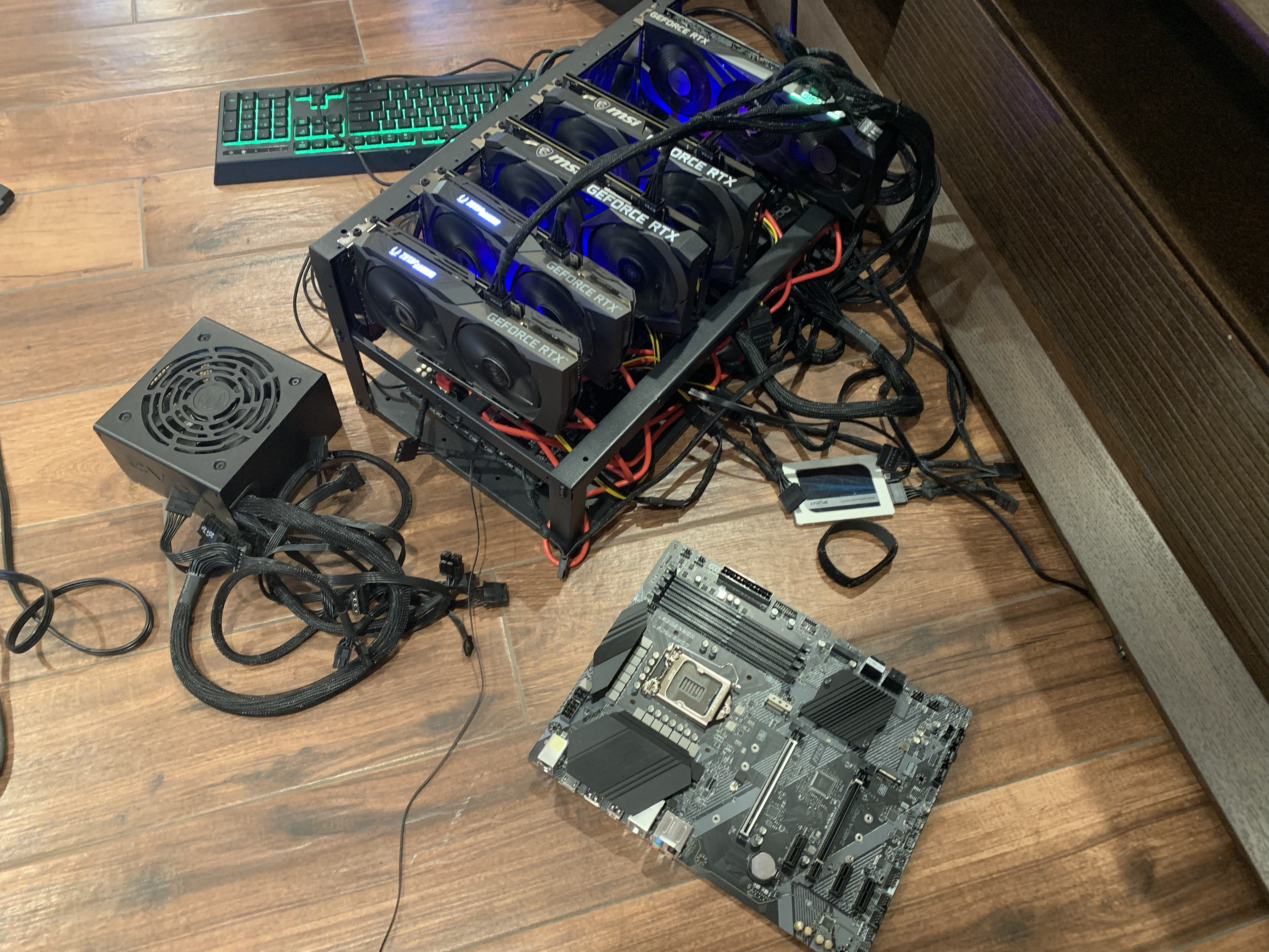 Bitcoin mining rig operation with GPUs and equipment.